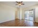 Bedroom with wood floors, ceiling fan, and sliding glass doors leading to patio at 1828 W Hemingway Ln, Anthem, AZ 85086