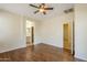 Bedroom with wood floors, view to bathroom, and doorways into other areas at 1828 W Hemingway Ln, Anthem, AZ 85086