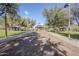 Pathway leading to picnic pavilions surrounded by mature trees and green space in a Gathering-friendly community park at 1828 W Hemingway Ln, Anthem, AZ 85086