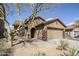 Charming home exterior with a two-car garage, desert landscaping, and tile roof at 1828 W Hemingway Ln, Anthem, AZ 85086