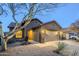 Charming single-story home featuring desert landscaping, a two-car garage, and a welcoming arched entryway at 1828 W Hemingway Ln, Anthem, AZ 85086