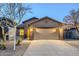 Charming single-story home showcasing desert landscaping and an attached two-car garage at 1828 W Hemingway Ln, Anthem, AZ 85086