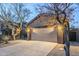 Exterior view of the home with a two-car garage, a desert landscaped yard, and an extended driveway at 1828 W Hemingway Ln, Anthem, AZ 85086