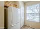 View of the kitchen with a white refrigerator, window, and tan walls at 1828 W Hemingway Ln, Anthem, AZ 85086