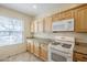 Bright kitchen featuring wood cabinets, granite counters, and a gas range at 1828 W Hemingway Ln, Anthem, AZ 85086