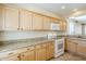 A kitchen featuring wooden cabinets, granite countertops, and modern appliances, including a white gas range at 1828 W Hemingway Ln, Anthem, AZ 85086