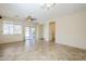 Bright living room with tile floors, a ceiling fan, large windows and sliding glass doors to the backyard at 1828 W Hemingway Ln, Anthem, AZ 85086