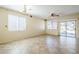 Open living room with tile flooring, ceiling fan, and sliding glass doors at 1828 W Hemingway Ln, Anthem, AZ 85086