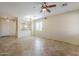 Open living room with tile flooring, ceiling fan, and views to the kitchen at 1828 W Hemingway Ln, Anthem, AZ 85086