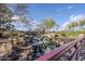 Beautiful community water feature with cascading waterfalls, surrounded by lush greenery and natural rock formations at 1828 W Hemingway Ln, Anthem, AZ 85086