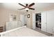 Bright bedroom featuring a white dresser, ceiling fan, closet and soft carpeting at 1920 E Manzanita Dr, Phoenix, AZ 85020