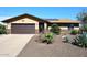 Single-story home featuring a two-car garage, desert landscaping, and stone veneer accents on the facade at 1920 E Manzanita Dr, Phoenix, AZ 85020