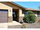 Home exterior displaying desert landscaping, a two-car garage, and stone details for added curb appeal at 1920 E Manzanita Dr, Phoenix, AZ 85020