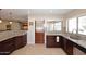 Modern kitchen featuring granite countertops, dark wood cabinets, and a sink with a window view at 1920 E Manzanita Dr, Phoenix, AZ 85020