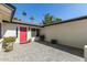 Inviting front entrance with a bright red door, lush landscaping, and a quaint tiled patio at 1974 E Vinedo Ln, Tempe, AZ 85284