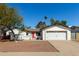 Charming single-story home featuring a bright red front door and a well-maintained two-car garage at 1974 E Vinedo Ln, Tempe, AZ 85284