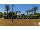 View of the community pool area, with palm trees and ramadas at 2013 N 77Th Gln, Phoenix, AZ 85035