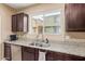 The kitchen boasts granite countertops, stainless steel appliances, and dark wood cabinets for a modern aesthetic at 2013 N 77Th Gln, Phoenix, AZ 85035