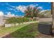 Wide backyard featuring lush green grass, mature landscaping, and a sturdy fence at 20916 E Desert Hills Blvd, Queen Creek, AZ 85142