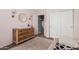 Bedroom with pale pink walls, dark wood dresser, and neutral accents at 20916 E Desert Hills Blvd, Queen Creek, AZ 85142