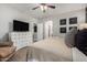 Bedroom featuring carpet, ensuite bathroom, TV, dresser and chair at 20916 E Desert Hills Blvd, Queen Creek, AZ 85142