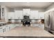 Well-lit kitchen featuring white cabinetry, stainless appliances, and center island at 20916 E Desert Hills Blvd, Queen Creek, AZ 85142