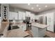 Bright kitchen featuring white cabinets, stainless steel appliances, and a functional island at 20916 E Desert Hills Blvd, Queen Creek, AZ 85142