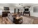 Bright and inviting living room with a cozy sofa, area rug, and hardwood floors, perfect for relaxing with Gathering and friends at 20916 E Desert Hills Blvd, Queen Creek, AZ 85142