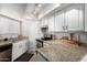 Well-lit kitchen features granite countertops and white cabinetry at 2228 N 52Nd St # 117, Phoenix, AZ 85008