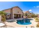 Backyard with pool, patio, comfortable seating, and well-manicured landscaping at 2450 E Glass Ln, Phoenix, AZ 85042