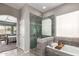 Luxurious bathroom featuring a tub and a separate glass-enclosed shower at 2450 E Glass Ln, Phoenix, AZ 85042