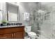 Bathroom featuring marble-tiled shower, granite countertop vanity, and a modern sink and faucet at 2450 E Glass Ln, Phoenix, AZ 85042