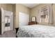 Bedroom with a sliding closet door, window with sheer curtain, and carpeted floor at 2450 E Glass Ln, Phoenix, AZ 85042