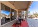 Relaxing covered patio with lounge seating, outdoor dining area, and an adjacent pool at 2450 E Glass Ln, Phoenix, AZ 85042