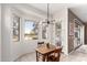 Cozy dining area adjacent to the kitchen with bright windows and stylish lighting fixture at 2450 E Glass Ln, Phoenix, AZ 85042