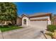 Charming single story home with a well-manicured lawn, desert landscaping and a two car garage at 2450 E Glass Ln, Phoenix, AZ 85042