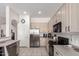 Well-lit kitchen with stainless steel appliances, ample counter space and tile flooring at 2450 E Glass Ln, Phoenix, AZ 85042