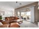 Inviting living room with sliding glass doors, sleek ceiling fan, and a seamless open-concept design at 2450 E Glass Ln, Phoenix, AZ 85042