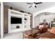 Inviting living room with custom built-ins, sleek ceiling fan, and an open-concept design at 2450 E Glass Ln, Phoenix, AZ 85042