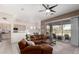 Inviting living room with sliding glass doors, sleek ceiling fan, and a seamless open-concept design at 2450 E Glass Ln, Phoenix, AZ 85042