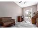 Bright living room featuring a comfortable sofa, large window, and traditional furnishings at 2450 E Glass Ln, Phoenix, AZ 85042