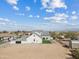 A beautiful white home featuring a manicured yard under a bright blue sky with fluffy white clouds at 2457 W Phillips Rd, Queen Creek, AZ 85144