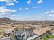 Expansive aerial view showcasing a modern white home, desert landscaping and neighborhood amenities in a serene community setting at 2457 W Phillips Rd, Queen Creek, AZ 85144