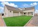 Exterior of a home with a spacious backyard featuring manicured turf at 2457 W Phillips Rd, Queen Creek, AZ 85144