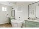 Elegant bathroom showcasing a freestanding tub, dual vanities, and chic fixtures at 2457 W Phillips Rd, Queen Creek, AZ 85144