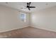 Neutral bedroom with ceiling fan and window offering natural light at 2457 W Phillips Rd, Queen Creek, AZ 85144