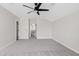 Large bedroom with gray carpet and view into another room at 2457 W Phillips Rd, Queen Creek, AZ 85144