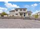 Charming two-story home with a blue front door, neutral stucco, dark shutters, and a low-maintenance rock front yard at 2457 W Phillips Rd, Queen Creek, AZ 85144