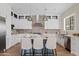 Bright kitchen with a central island, modern appliances, and stylish pendant lighting at 2457 W Phillips Rd, Queen Creek, AZ 85144