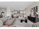 Spacious living room featuring modern decor and an open-concept design to the kitchen at 2457 W Phillips Rd, Queen Creek, AZ 85144